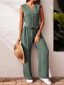 Detailed lifestyle view of a green linen two-piece set with vest and wide-leg trousers.