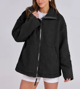 Women's oversized black teddy fleece jacket featuring warm texture and double zipper detail.