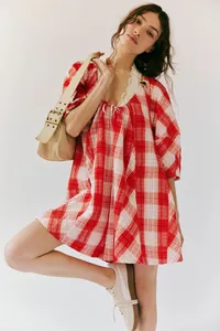 Detail view of red and white checkered summer romper with lace trim and V-neckline