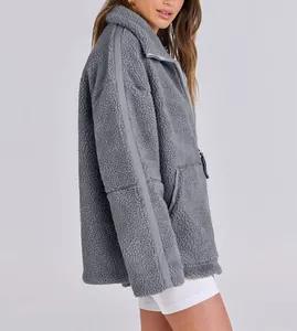 Side view of a gray oversized teddy fleece jacket for women showing soft texture