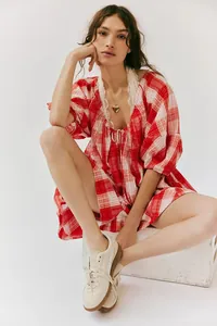 Model wearing a stylish red and white plaid short sleeve romper with lace detailing