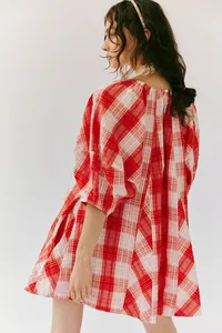 Detailed view showing the loose fit and red white plaid pattern of this summer romper