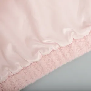 Close-up of soft pink shearling and satin lining on casual winter jacket