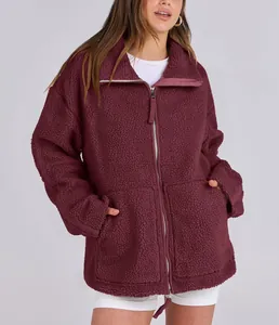 Detailed view of women's oversized burgundy teddy fleece jacket with dual zipper