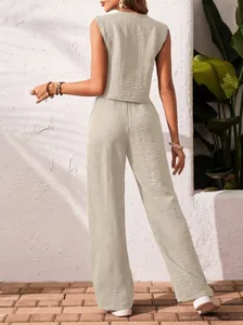 Back view of a chic beige linen two-piece set featuring textured vest and wide-leg trousers