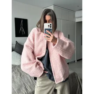 Stylish pink fuzzy sherpa jacket with drop shoulders for a trendy casual winter look
