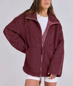 Detail of burgundy oversized teddy plush jacket with double zipper for winter