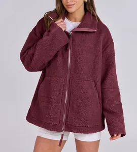 Cozy burgundy oversized teddy jacket with double zipper and front pockets.