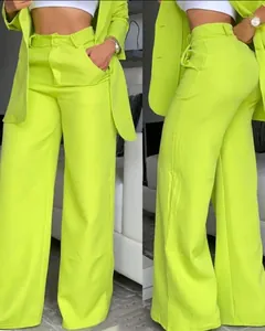 Detailed view of women's lime green blazer and wide-leg trousers set for summer commute fashion