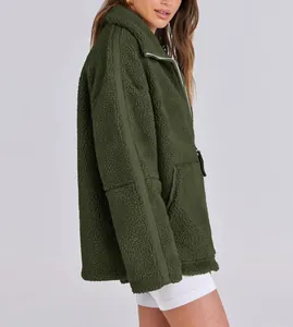 Side view of an oversized olive green teddy fleece jacket with double zipper detail.