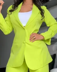 Detailed shot of elegant lime green women's suit set with split sleeves and lapel