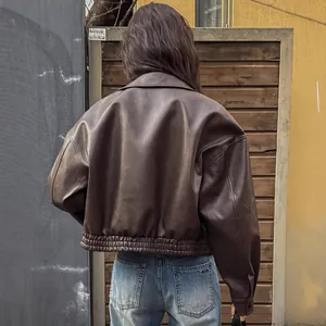 Detailed back view of a vintage brown PU leather motorcycle jacket with elastic hem