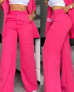 Detail view of vibrant pink high-waisted wide-leg trousers with front and side profile