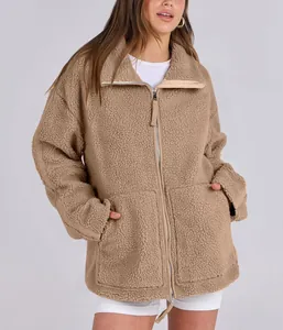 Close-up of a women's oversized teddy fleece jacket featuring a functional double zipper