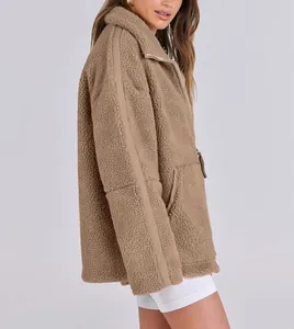 Detail view of khaki teddy fleece jacket showing plush texture and oversized fit