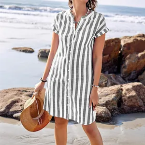 Casual women's grey and white vertical striped button-down summer shirt dress for beach
