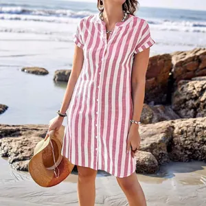 Women's stylish summer casual red and white striped button-down shirt dress on beach