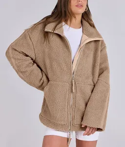 Detail view of brown oversized teddy fleece jacket with double zipper and mock neck