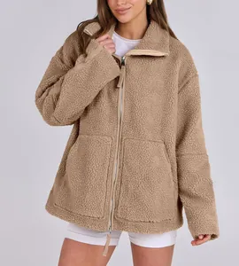 Close-up of oversized khaki teddy jacket with double zipper and soft plush texture