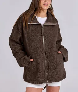 Detail of oversized brown teddy fleece jacket with front zipper and pockets