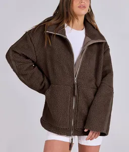 Detail showing the oversized fit and double zipper of this brown teddy fleece winter jacket