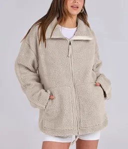 Detailed view of women's oversized warm teddy fleece jacket featuring double zipper and pockets.