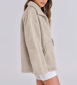 Side view of a stylish oversized beige sherpa teddy jacket showing soft plush texture.