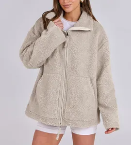 Detailed view of a women's beige oversized sherpa fleece jacket with double zipper