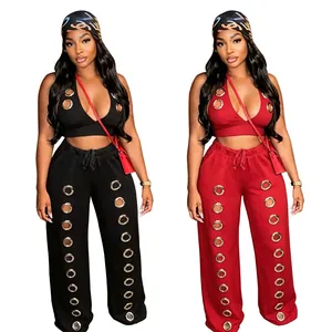 Chic two-piece streetwear set featuring halter crop top and metal grommet wide-leg pants