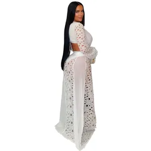 Detailed view of a white lace mesh maxi dress featuring side slits and long sleeves.