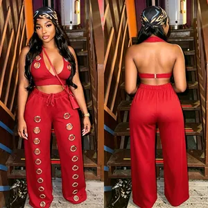 Front and back detail of a red wide-leg set with decorative gold eyelets