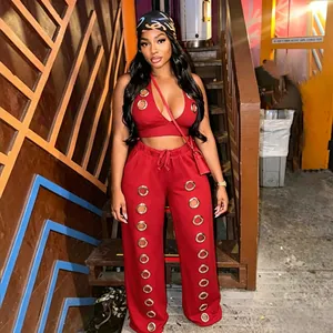 Full styling view of the trendy red grommet halter top and matching wide-leg pants set.