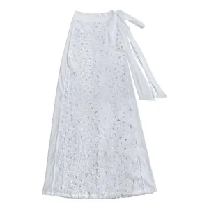 Close-up detail of the intricate floral lace and tie-up waist on this white summer skirt