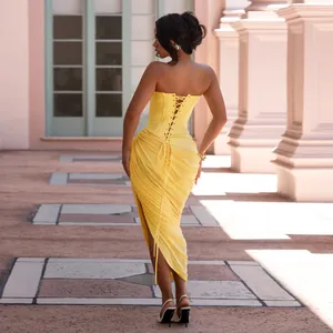 Close-up of the yellow strapless corset dress showing the lace-up back and ruched details