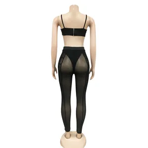 Black two-piece set featuring mesh perspective leggings and a cropped camisole top