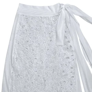 Macro view of white floral lace dress detailing featuring mesh panels and side tie waist