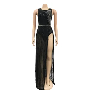 Close-up of black fringe nightclub dress with rhinestone and sequin details on mesh fabric