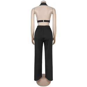 Back view of a chic black halter neck crop top and loose straight-leg pants set