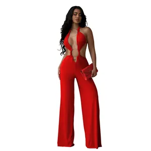 Detail shot of red halter neck cutout jumpsuit with metal rings and wide leg design.