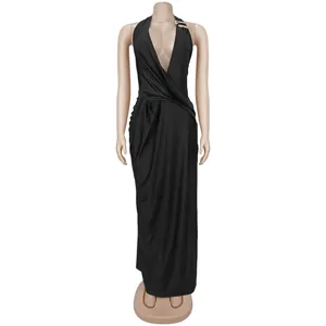 Elegant black backless halter maxi dress with a deep V-neckline and decorative brooch