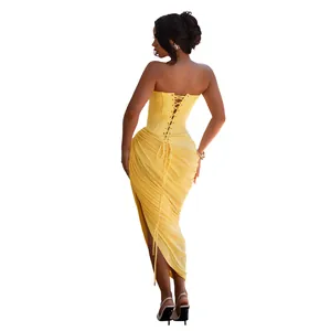 Back detail of yellow strapless dress with corset lacing and pleated draping