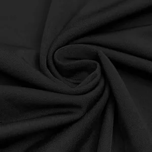 Primer plano detallado de la tela negra de un vestido de noche con elegantes pliegues espirales
