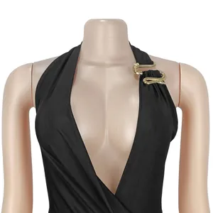 Detailed view of sexy black deep V halter dress featuring ornate golden snake hardware detail