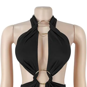 Close-up detail of sexy black halter jumpsuit with golden ring accents and cutouts