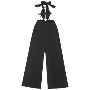 Detail view of a black sexy halter neck jumpsuit with cutout design and wide leg silhouette