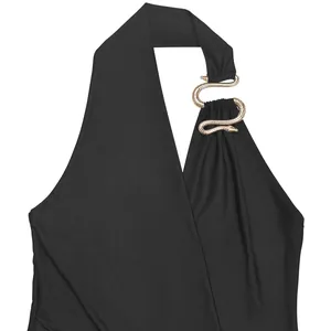 Close-up of golden snake buckle detail on black sexy deep V-neck halter dress