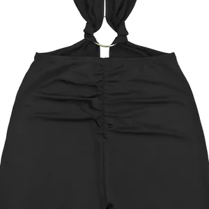Macro view of black backless jumpsuit featuring metallic ring and ruched detailing
