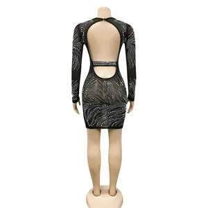 Back view of a black mesh mini dress with rhinestones and a sexy open back cutout