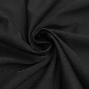 Macro detail of the high-quality black ribbed knit fabric showing soft texture and elasticity