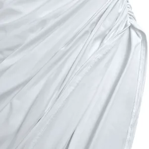 Close-up of white pleated fabric texture and stitching details on a bodycon dress